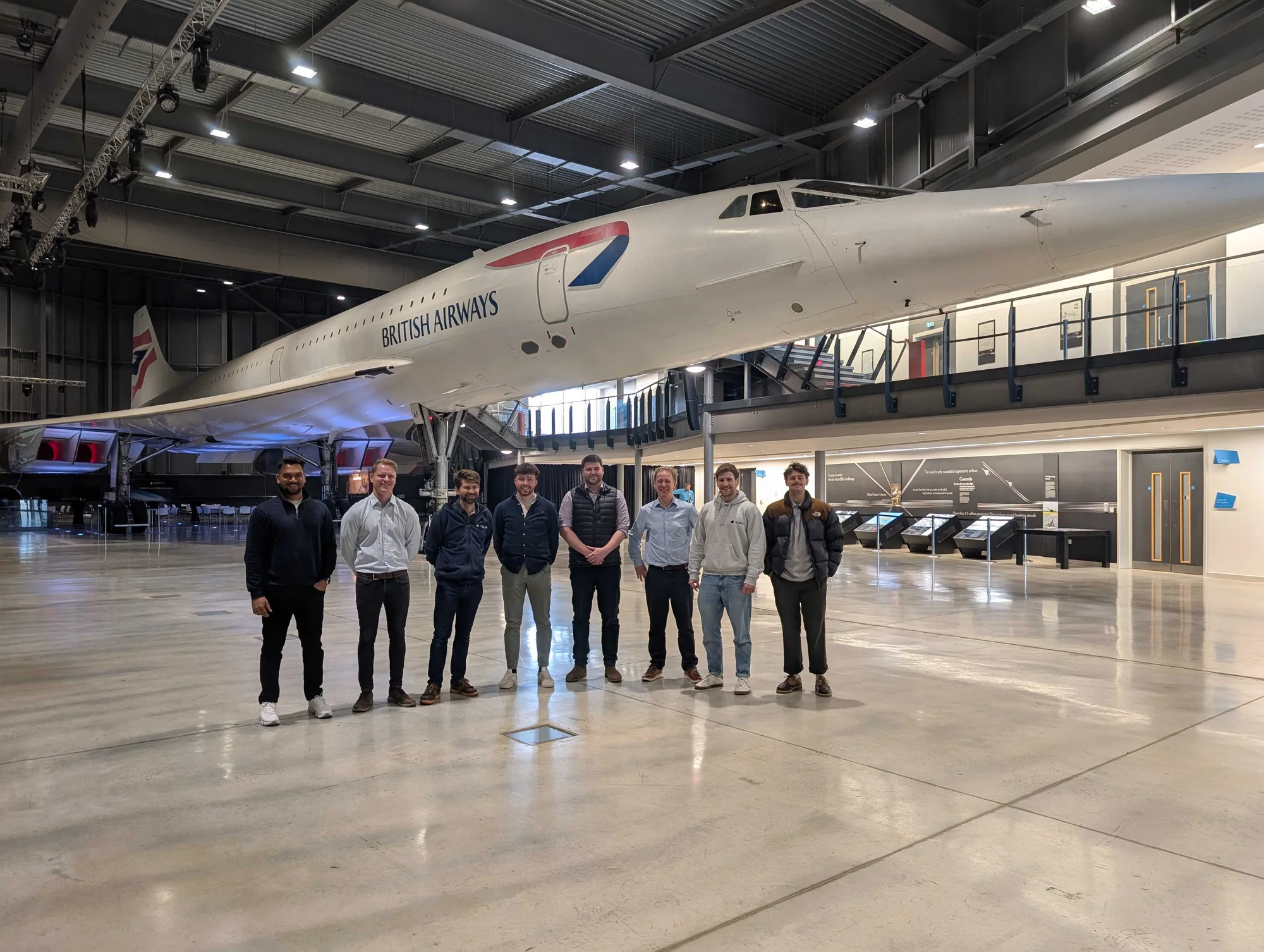 Rubik team standing beneath Concorde